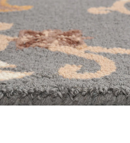 Handcrafted wool rug featuring gray base with gold accents