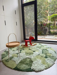 Hand-tufted green wool rug with pebble-inspired pattern and sculpted high-low texture