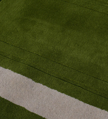 Luxury wool rug with embossed rectangle detail in green tones