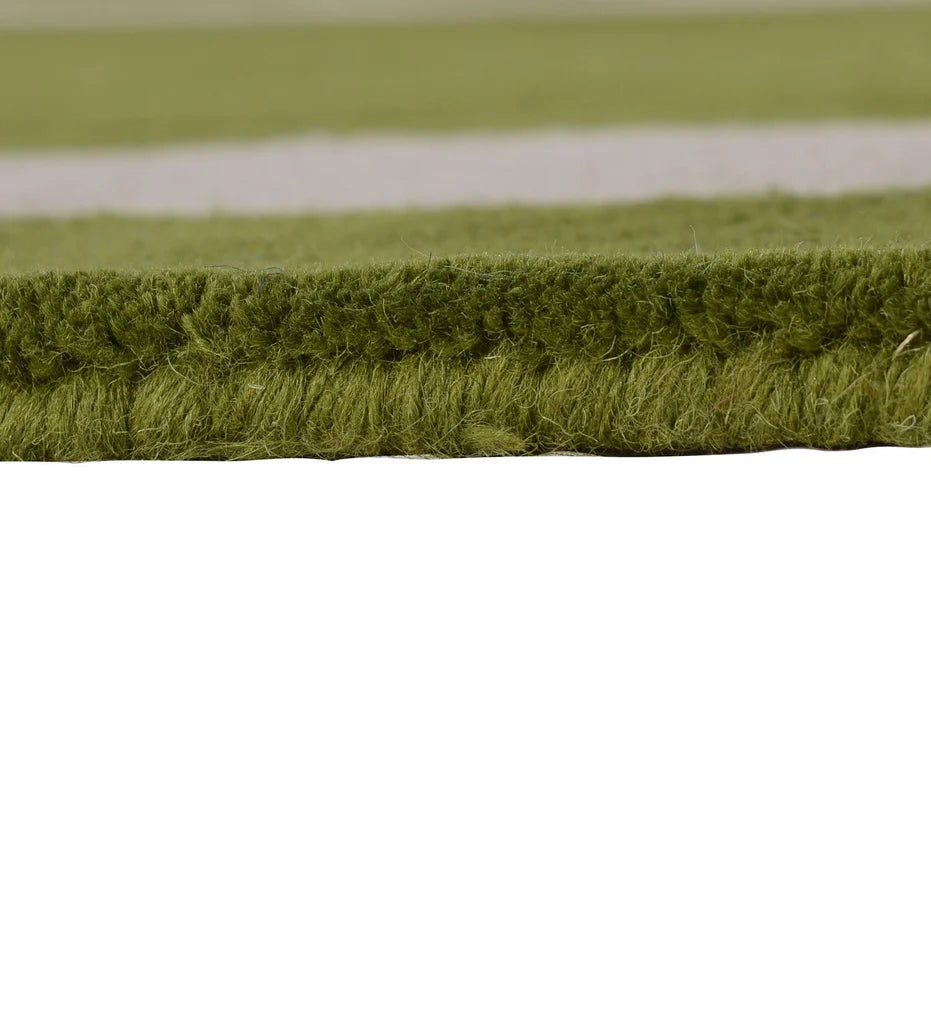Modern wool rug with green field and ivory frame design