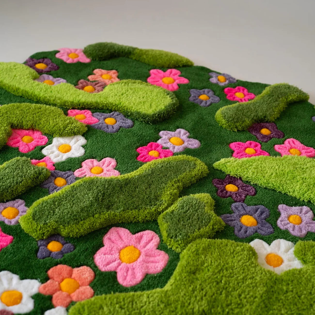Modern bohemian hand-tufted wool rug with layered green contours and multicolor flowers