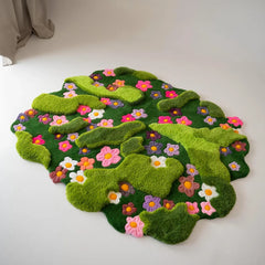 Hand-tufted green floral wool rug with raised moss texture and colorful wildflower design