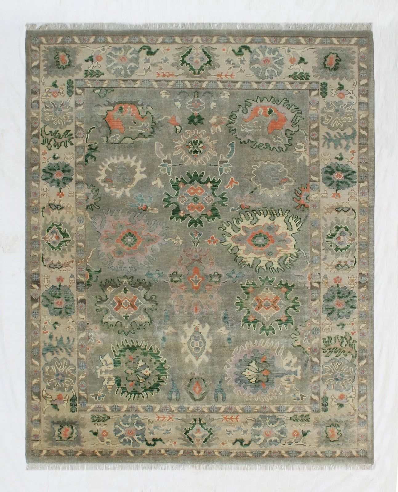 Hand-knotted green Oriental rug with floral medallion design