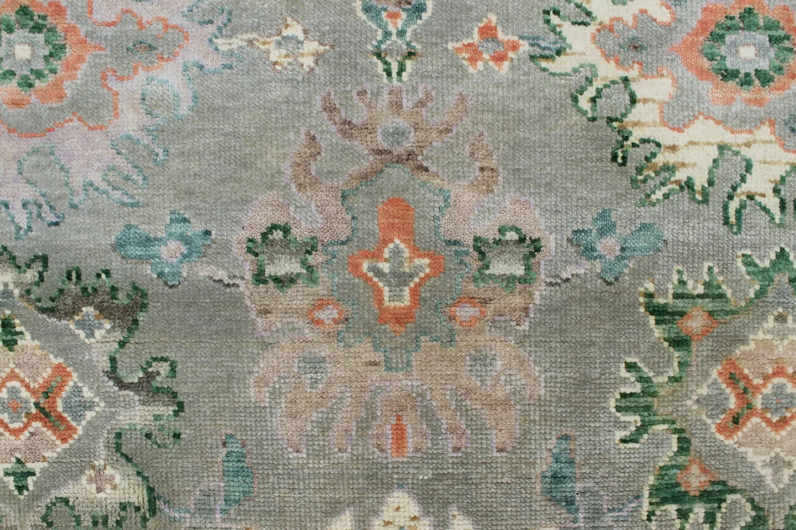Traditional wool rug in green with beige and ivory accents