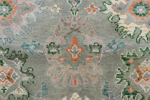 Traditional wool rug in green with beige and ivory accents