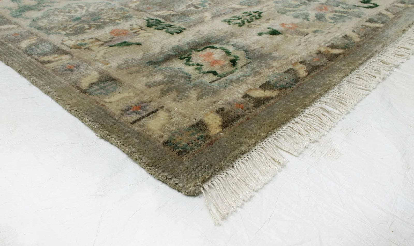 Elegant handwoven wool rug in green and gold tones