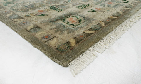 Elegant handwoven wool rug in green and gold tones