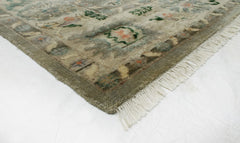 Elegant handwoven wool rug in green and gold tones