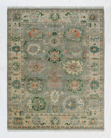 Hand-knotted green Oriental rug with floral medallion design