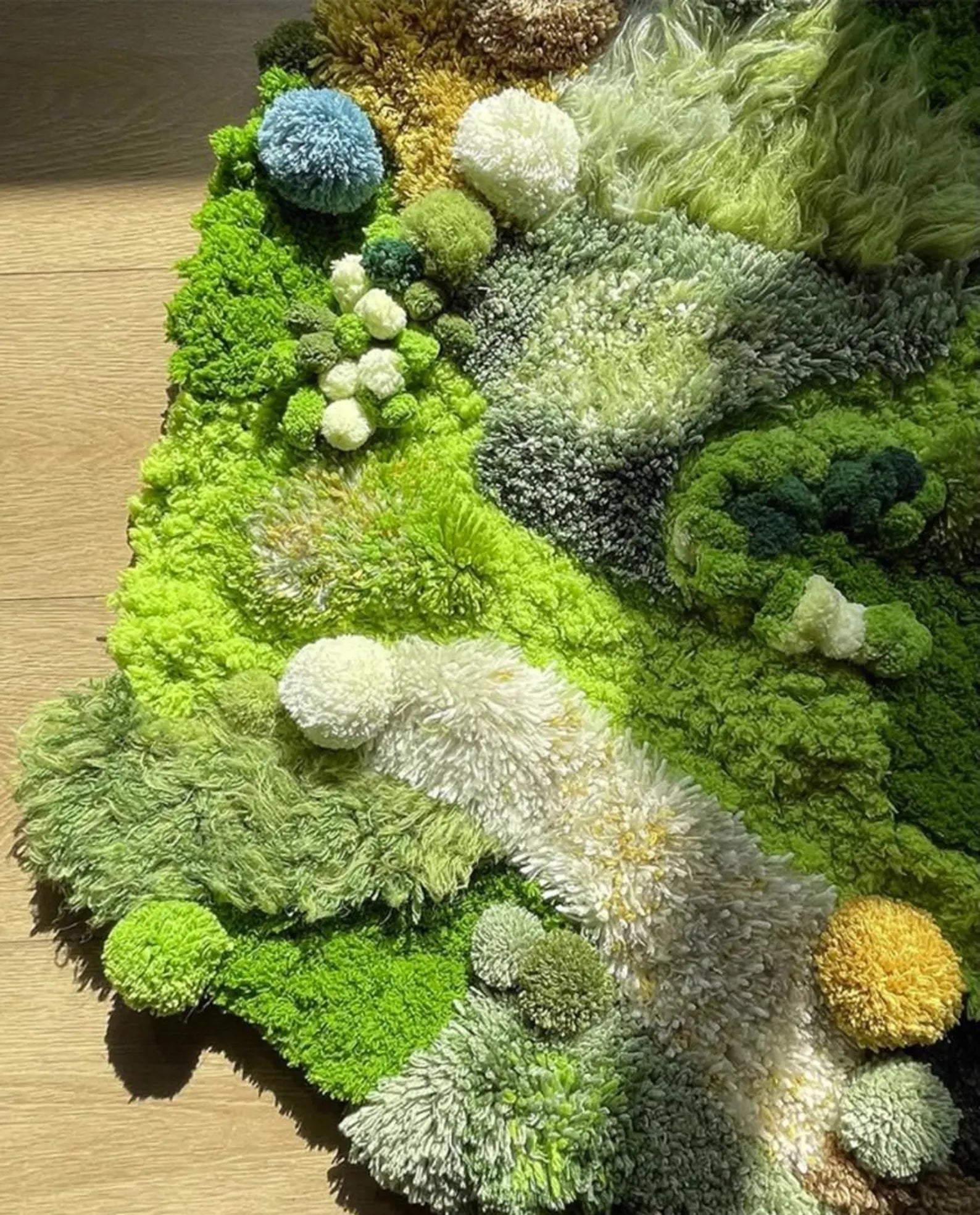 Artistic green hand-tufted area rug with dimensional pile and earth-tone accents