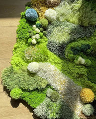 Artistic green hand-tufted area rug with dimensional pile and earth-tone accents