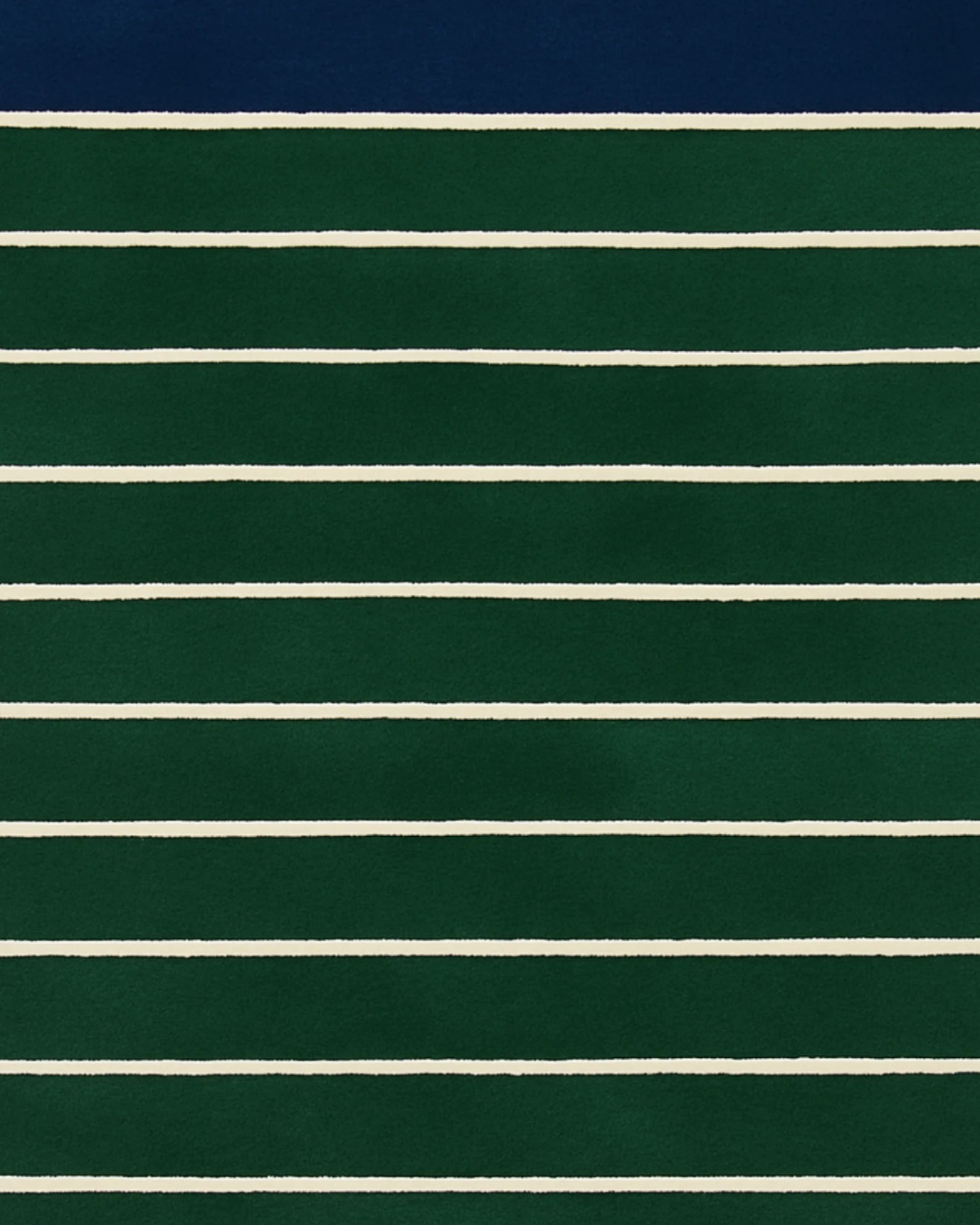 Green and navy hand-tufted wool rug with ivory lines.