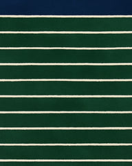 Green and navy hand-tufted wool rug with ivory lines.