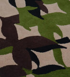 Luxury wool rug with abstract leaf motif on beige background