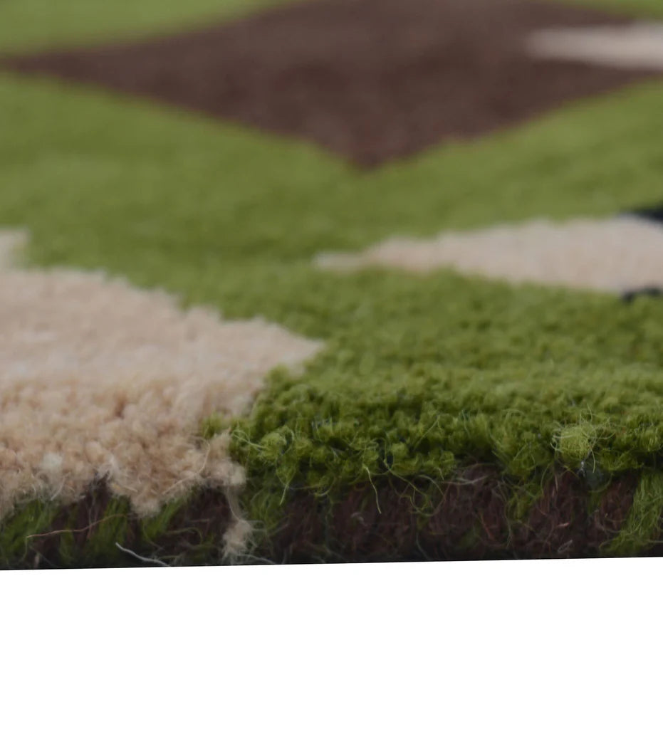 Modern hand-tufted rug featuring bold green and brown abstract design