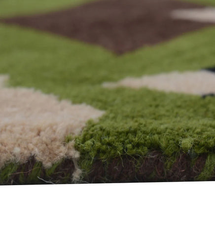 Modern hand-tufted rug featuring bold green and brown abstract design