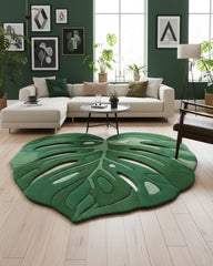 Green gradient monstera leaf–shaped irregular area rug styled in a living room, featuring layered botanical tones that add a fresh, nature-inspired focal point