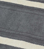 Close-up of a grey solid hand-tufted wool runner with textured stripes and cream accents