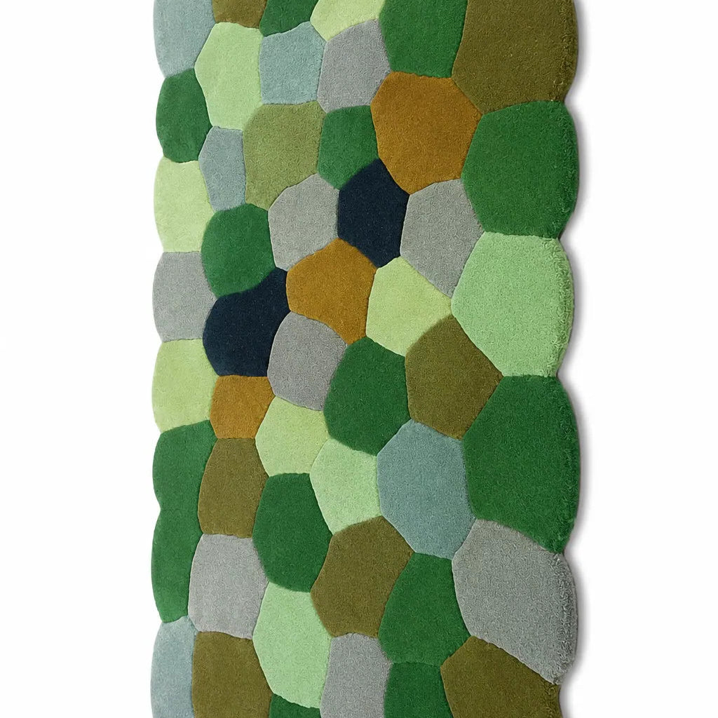 Hexagonal patchwork rug with green, brown, and gray colors on a white background