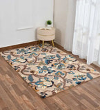 Beige floral area rug with blue and yellow accents in a modern living room with wood flooring.