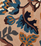 Beige area rug with blue, gold, and brown abstract floral pattern