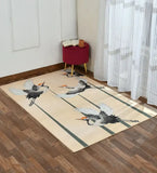 Ivory rug with elegant flying crane bird design on wooden floor in a bright room with white curtains and red stool