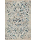 Ivory distressed Persian design rug with faded teal and black floral patterns