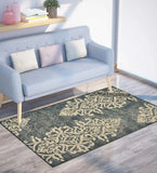 Ivory and charcoal vintage faded rug with intricate floral pattern under light blue sofa in modern living room