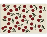 Modern cherry design rug with red motifs and green stems on an ivory base.