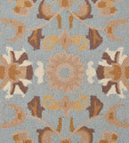 Close-up of light blue and beige traditional rug with floral and geometric patterns