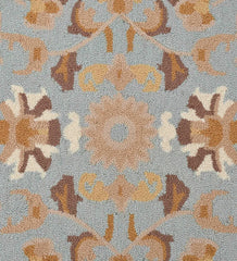 Vintage-style area rug with intricate beige and blue pattern.