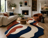 Living room with a colorful rug, sofa, coffee table, and fireplace.