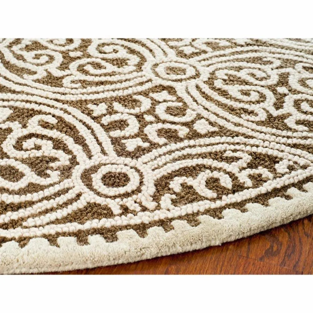 Handcrafted circular beige and taupe wool area rug.