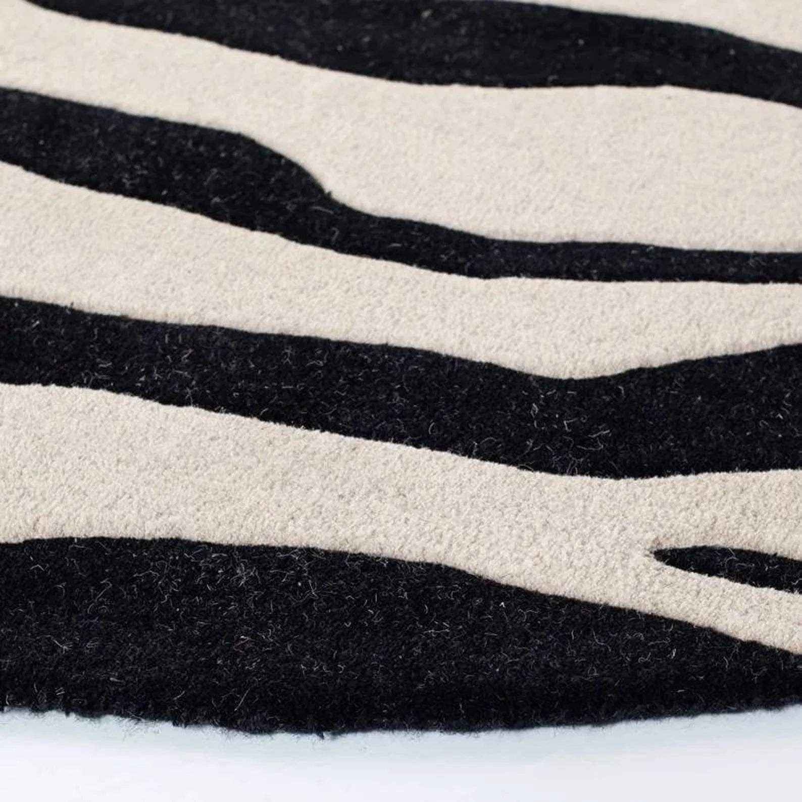 Bold zebra design wool rug in ivory base.
