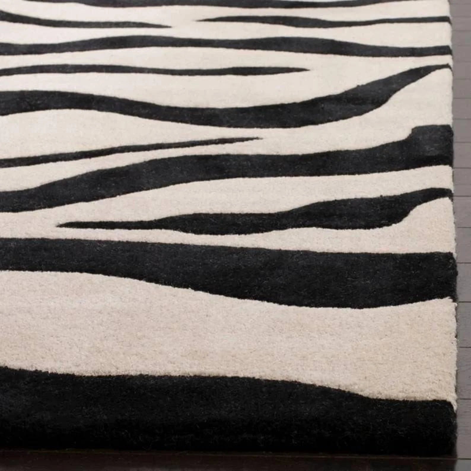 Handmade black and ivory animal print area rug.