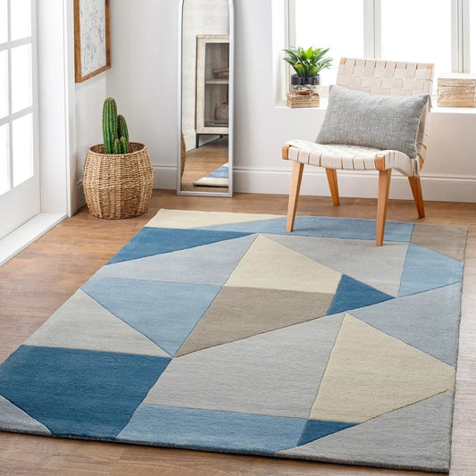 Modern wool rug with abstract angular design in soft blue tones.