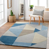 Modern wool rug with abstract angular design in soft blue tones.