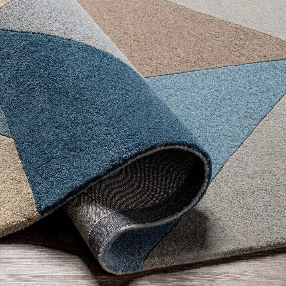 Abstract modern wool rug in blue, ivory, and taupe colors.