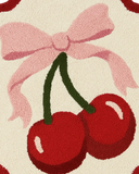 Handcrafted cherry-themed circular wool rug for modern interiors.