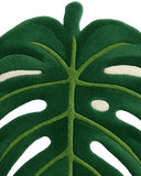 Green monstera-shaped wool rug for tropical interior décor.