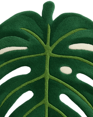 Green monstera-shaped wool rug for tropical interior décor.