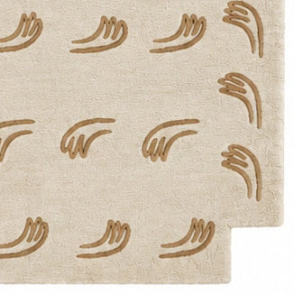 A rectangular area rug in a light beige or cream tone with a repeating pattern of small brown leaf or vine motifs, shown flat against a plain white background.