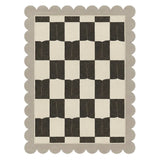 Checkered pattern rug with scalloped edge on a white background