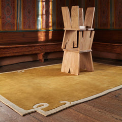 Luxury solid brown area rug with abstract corner design.