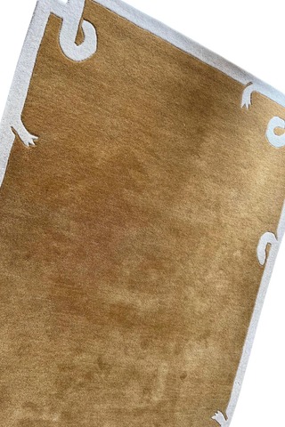 Solid brown minimalist wool rug with ivory artistic borders.