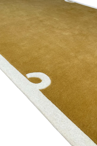 Premium camel brown wool rug with subtle border detailing.