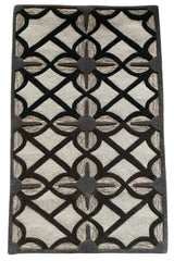 Hand-tufted beige rug with bold black lattice pattern.
