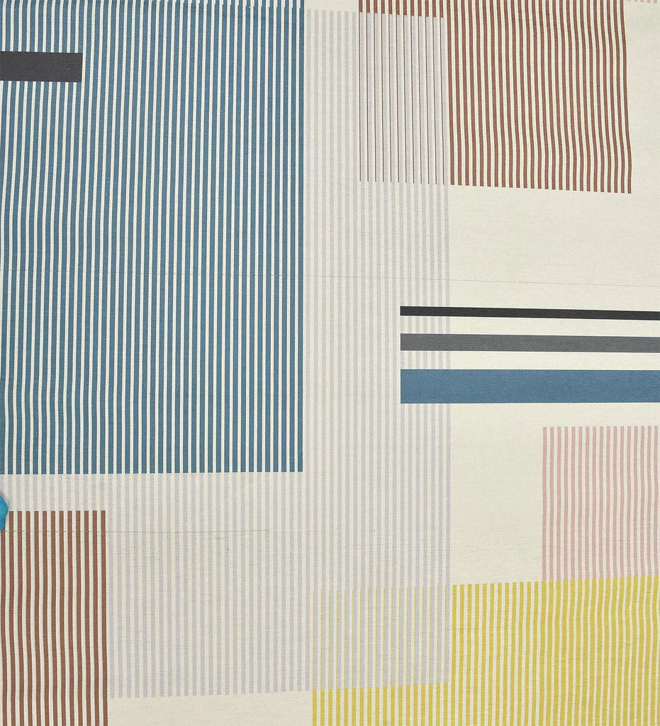 Low-profile modern rug with mustard, teal, and terracotta accents.
