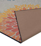 Close-up of luxury floral rug with orange and yellow petals design and beige backing, handwoven carpet edge detail