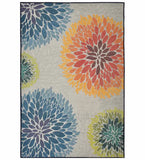Modern floral area rug with large colorful flower motifs in blue, orange, green on beige background